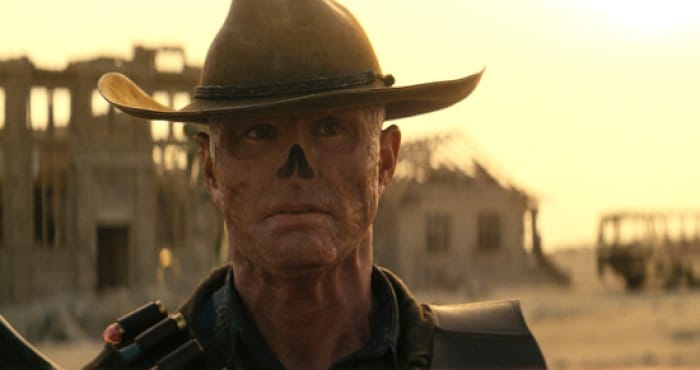 A screenshot from Fallout Season One showing the ghoul Cooper Howard in a sun-drenched desert wasteland