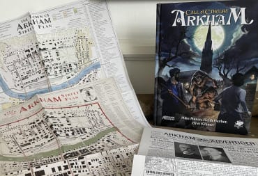 An image of Call of Cthulhu: Arkham and its various included player resources, like a map and fake newspaper.